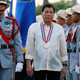 Philippine President Rodrigo Duterte reviews the troops as he leads the flag-raising ceremony to commemorate the 120th death anniversary of the country’s national hero Jose P. Rizal Friday, Dec. 30, 2016 in Manila, Philippines. Détente remains popular as shown by recent surveys despite international concerns about his war on drugs that has so far killed more than 6,000 drug suspects since he took office June 30. (AP Photo/Bullit Marquez)